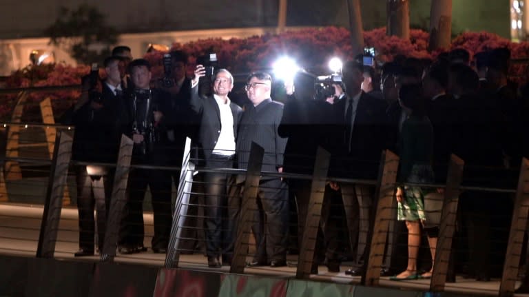 In a first, North Korean leader Kim Jong Un posed for a selfie with Singapore Foreign Minister Vivian Balakrishnan during an evening stroll through the city