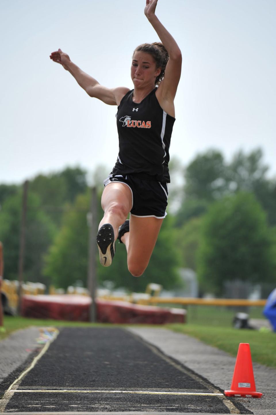 Lucas' Shelby Grover competes in the long jump at the Division III district meet.