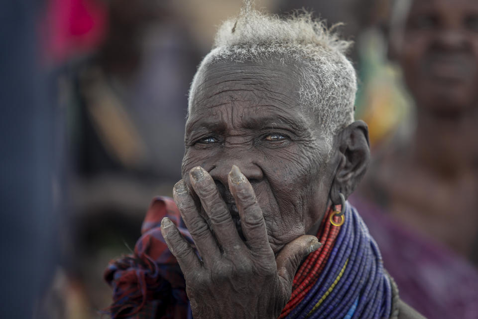 Villagers gather during a visit by United Nations Under-Secretary-General for Humanitarian Affairs Martin Griffiths, in the village of Lomoputh in northern Kenya Thursday, May 12, 2022. Griffiths visited the area on Thursday to see the effects of the drought which the U.N. says is a severe climate-induced humanitarian emergency in the Horn of Africa. (AP Photo/Brian Inganga)