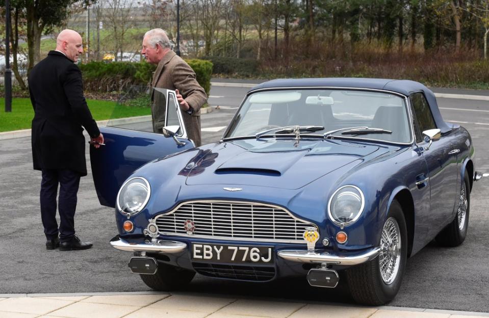 Charles with his Aston Martin DB6 which runs on run on surplus wine (Rebecca Naden/PA) (PA Archive)