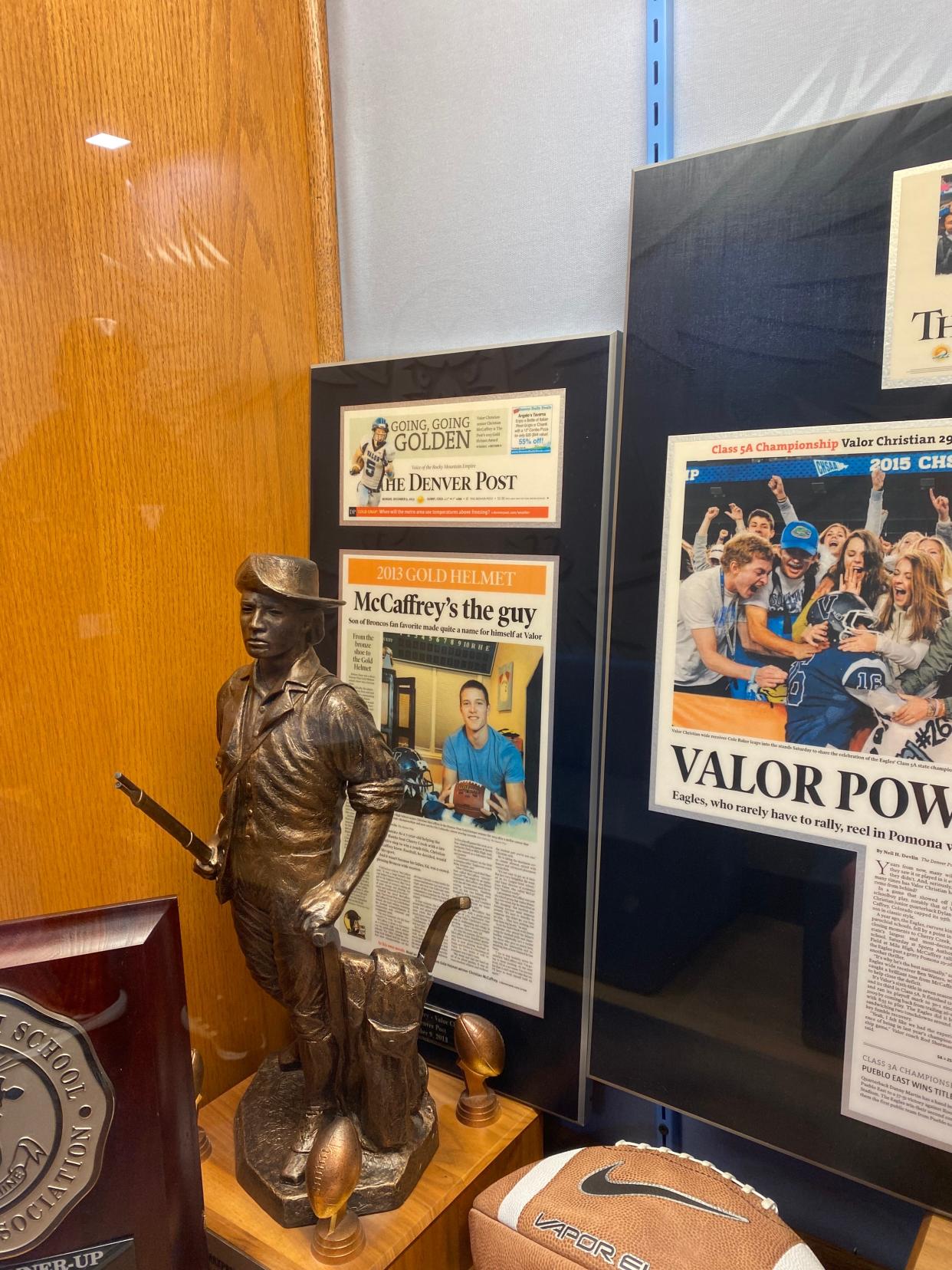 A news clipping of when Christian McCaffrey won the Denver Post's Gold Helmet award, given to the best football player in Colorado, sits in a trophy case at Valor Christian High School.