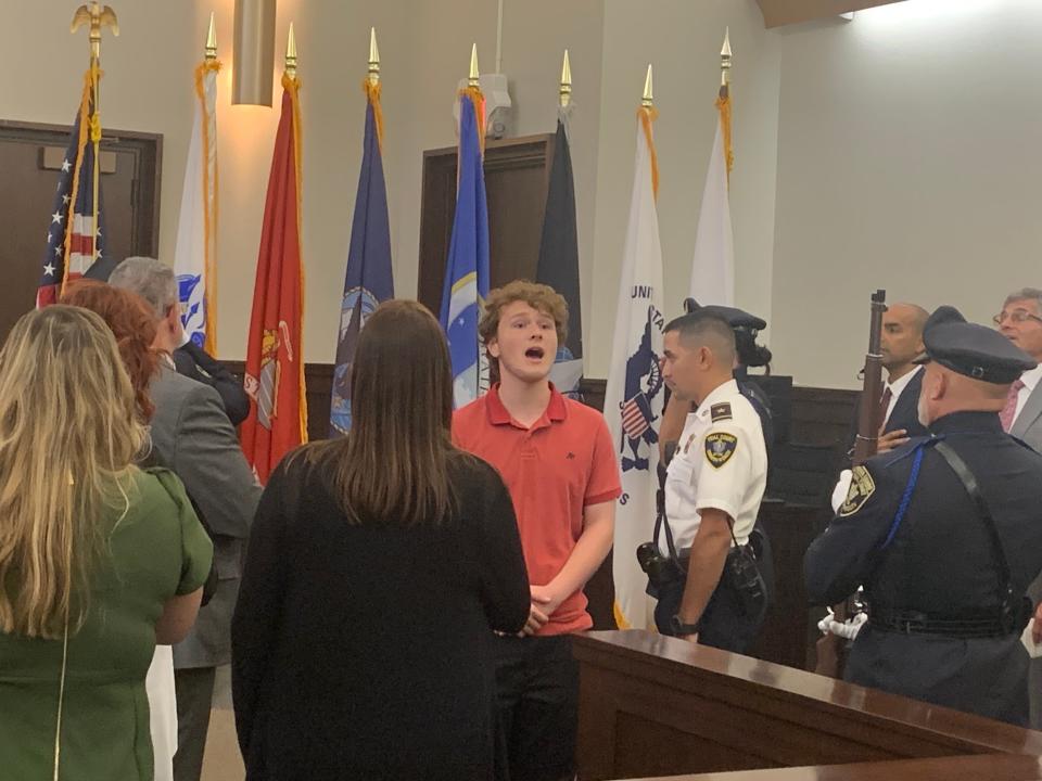 Gardner High School student Jonathan Hastings sings the National Anthem at the grand opening of the Central Massachusetts Veterans Treatment Court at Gardner District Court on Sept. 20.