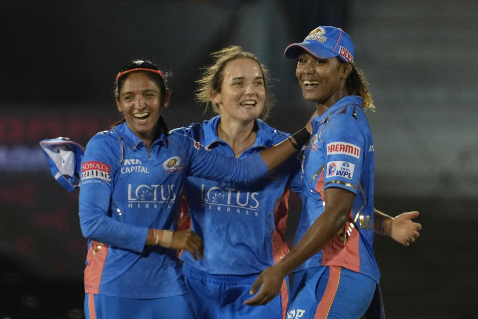 Mumbai Indians captain Harmanpreet Kaur, left, Amelia Kerr, centre, and Hayley Matthews celebrates the dismissal of Delhi Capitals Arundhati Reddy during during the Women's Premier League Twenty20 cricket final match between Delhi Captials and Mumbai Indians in Mumbai, India, Sunday, March 26, 2023. (AP Photo/Rajanish Kakade)