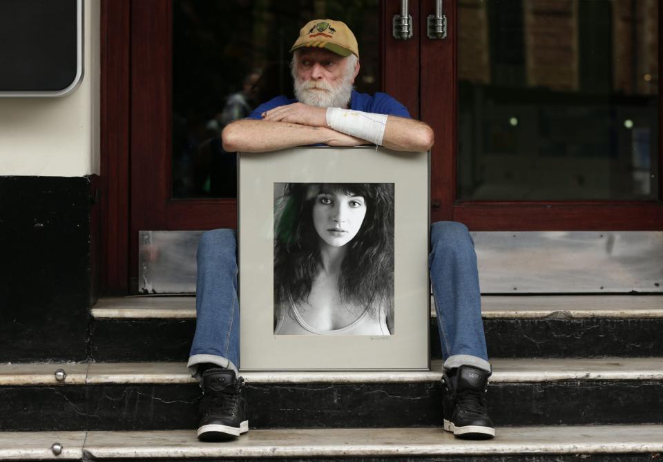 Waiting for the icon: a fan sits outside the venue for Kate Bush’s 2014 comeback – her first shows in 35 years. (Credit: Yui Mok/PA Images via Getty Images)