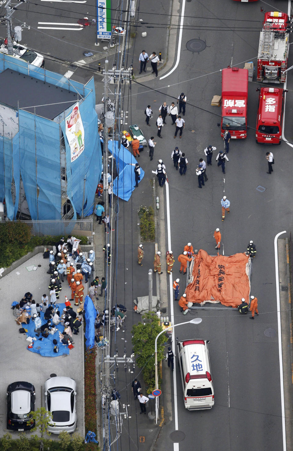 An aerial view shows rescue workers and police officers operate at the site where sixteen people were injured in a suspected stabbing by a man, in Kawasaki.
