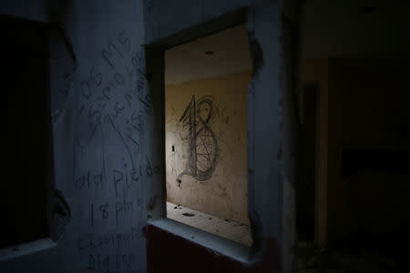 Barrio-18 graffiti is seen inside a so-called Crazy House in San Pedro Sula, Honduras, May 28, 2018. REUTERS/Edgard Garrido