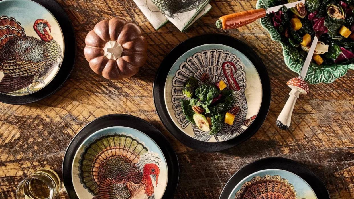  Close-up of thanksgiving table with colorful plates . 