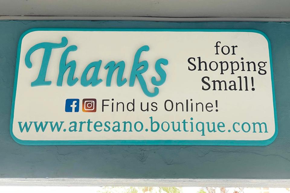 A sign above the door inside Artesano Boutique in downtown Fort Walton Beach thanks customers for shopping "small." The boutique is one of many downtown businesses that are gearing up for Small Business Saturday, the day after the traditional Black Friday holiday.