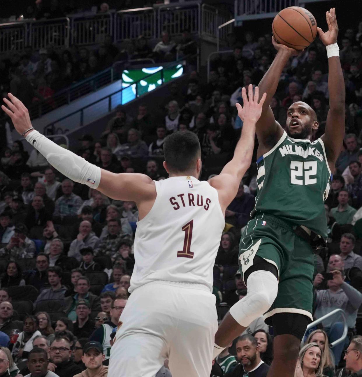 Milwaukee Bucks forward Khris Middleton (22) shoots over Cleveland Cavaliers guard Max Strus (1) during the second half of their game Wednesday, Jan. 24, 2024, at Fiserv Forum in Milwaukee. Bucks defeated the Cavaliers 126-116. Ebony Cox / Milwaukee Journal Sentinel