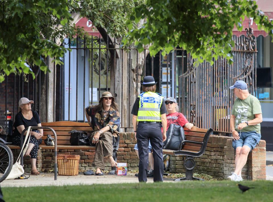 A Police Community Support Officer chats to people as they social distance in York, following the introduction of measures to bring England out of lockdown. (Photo by Danny Lawson/PA Images via Getty Images)