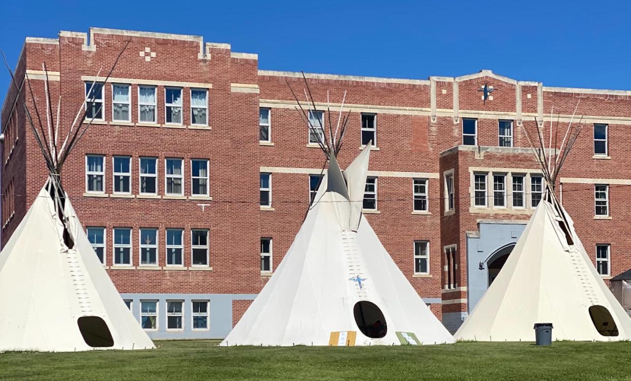 Ceremonial tipis sit in front of the former residential school, Blue Quills, now the home to Blue Quills university run by seven First Nations. (Terri Cardinal), Author provided