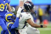 Denver Broncos quarterback Russell Wilson is tackled by Los Angeles Rams linebacker Leonard Floyd during the second half of an NFL football game between the Los Angeles Rams and the Denver Broncos on Sunday, Dec. 25, 2022, in Inglewood, Calif. (AP Photo/Marcio J. Sanchez)