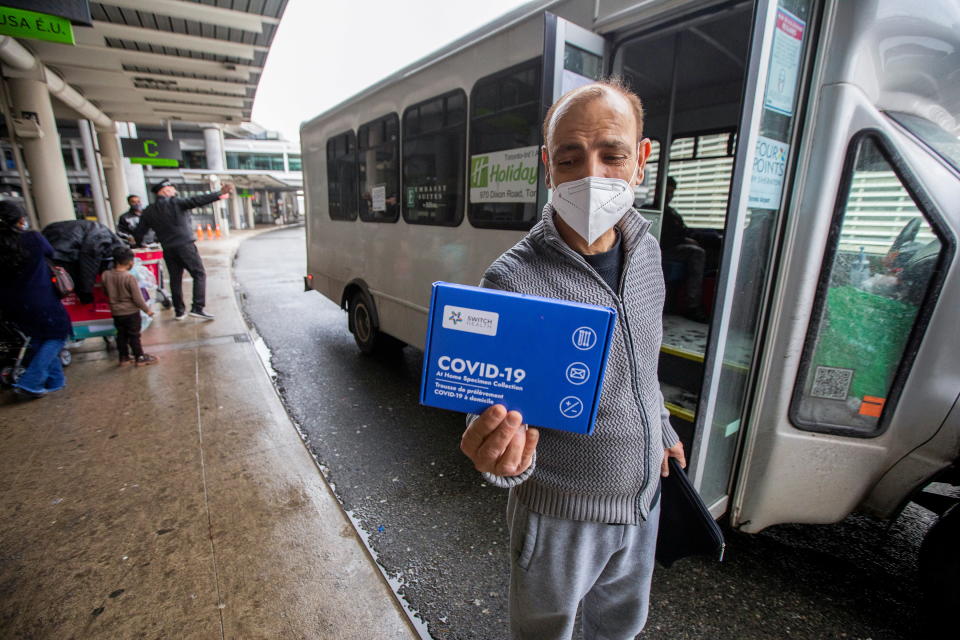 Chander Gawri shows the at-home COVID-19 test given to all international arrivals before he boards a shuttle which will take him to a quarantine hotel, as part of Canada's new measures against the coronavirus disease (COVID-19), at Toronto Pearson International Airport in Mississauga, Ontario, Canada February 24, 2021.  REUTERS/Carlos Osorio