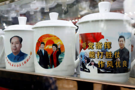 Souvenir cups with images of Chinese late Chairman Mao Zedong and Chinese President Xi Jinping are seen at a shop during the ongoing 19th National Congress of the Communist Party of China, in Beijing, China October 21, 2017. REUTERS/Tyrone Siu