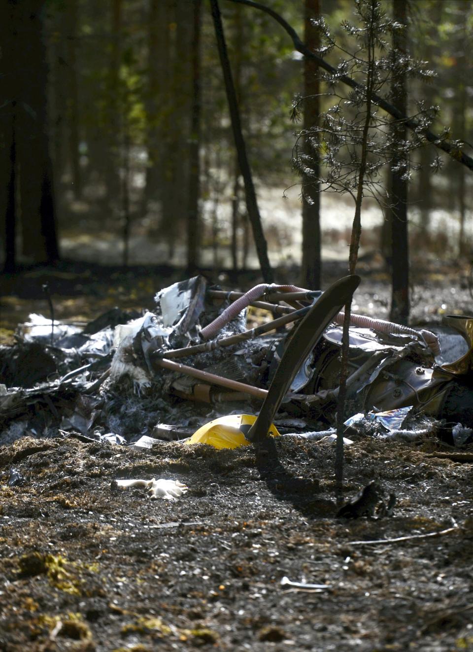 Wreckage of an aircraft covers the ground next to Jamijarvi Airfield, southwest Finland on Monday April 21, 2014. Finnish officials on Sunday eight people died when a small plane carrying parachutists crashed to the ground and caught fire. (AP Photo/LEHTIKUVA /Vesa Moilanen) FINLAND OUT