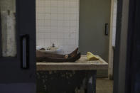 The body of a villager who was killed by suspected rebels as they retreated from Saturday's attack on the Lhubiriha Secondary School, lies in the mortuary of the hospital in Bwera, Uganda Sunday, June 18, 2023. Ugandan authorities have recovered the bodies of 41 people including 38 students who were burned, shot or hacked to death after suspected rebels attacked the school in Mpondwe near the border with Congo, according to the local mayor. (AP Photo/Hajarah Nalwadda)