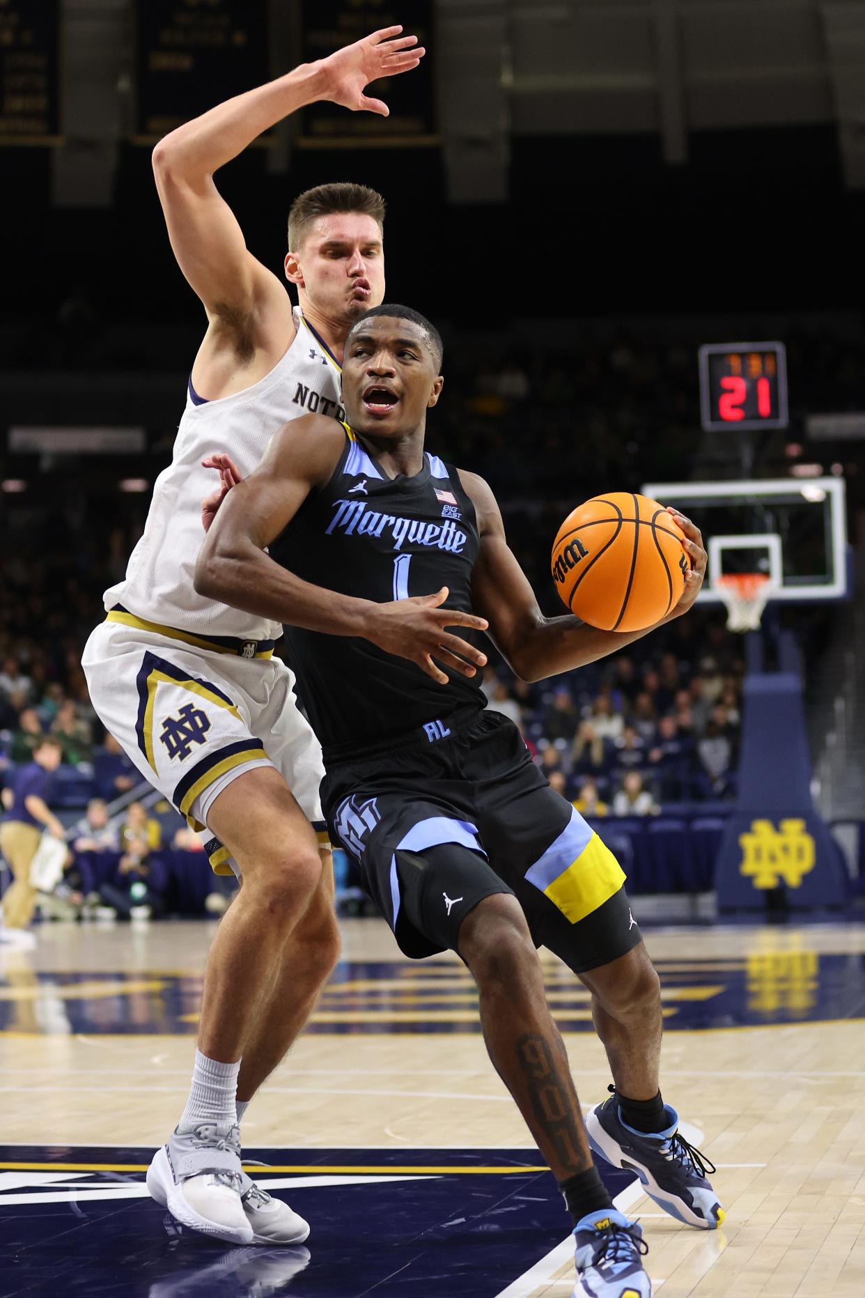 Marquette's Kam Jones drives against Notre Dame's Nate Laszewski in the second half on Sunday.