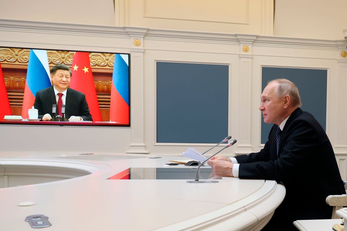 Russian President Vladimir Putin speaks with China President Xi Jinping in December 2022  (AP)