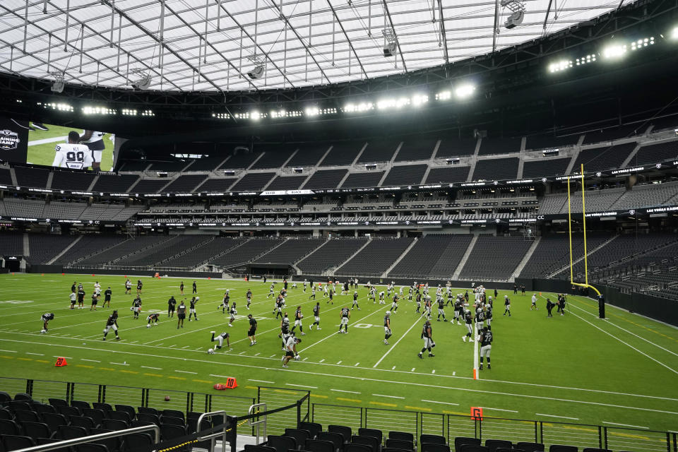 Las Vegas Raiders players warms up during an NFL football training camp practice at Allegiant Stadium, Friday, Aug. 28, 2020, in Las Vegas. (AP Photo/John Locher)