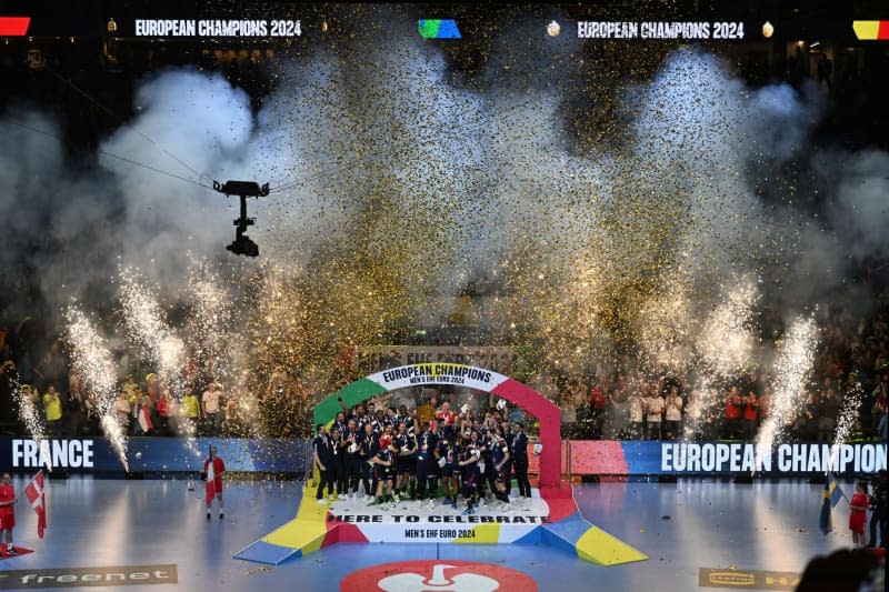 France's Luka Karabatić (C) lifts the trophy during the 2024 EHF European Men's Handball Final Match France vs. Denmark ceremony held at LANXESS Arena. Federico Gambarini/DPA