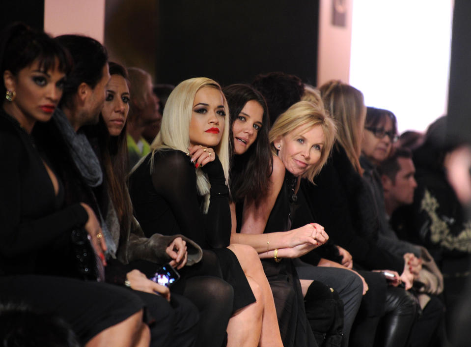 Rita Ora, center left, Katie Holmes, center, and Trudie Styler, center right, attend the Donna Karan New York Fall 2014 collection during Fashion Week, Monday, Feb. 10, 2014, at 23 Wall Street in New York. (AP Photo/Diane Bondareff)