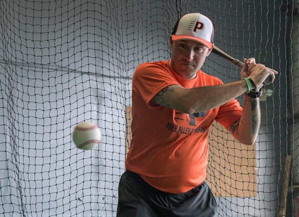 Jerod Mathis swings in a batting cage at Power Alley Performance in Leesburg. [PAUL RYAN / CORRESPONDENT]