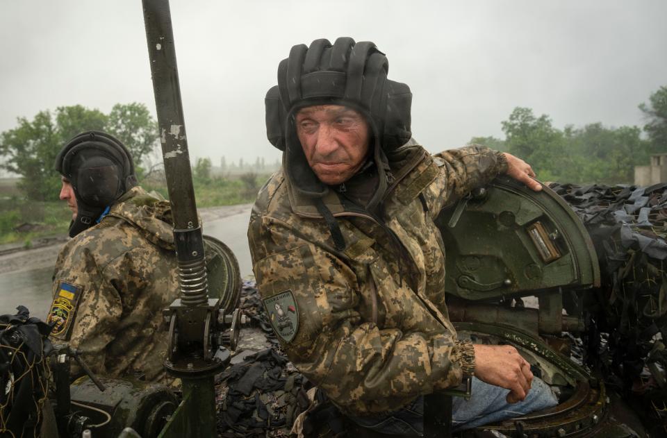 Ukrainian tankers ride along the road toward their positions near Bakhmut, Donetsk region, on Tuesday.