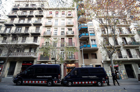 Mossos d'Esquadra police officers stand next to police cars near Sagrada Familia Basilica in Barcelona, Spain, December 12, 2018. REUTERS/Albert Gea