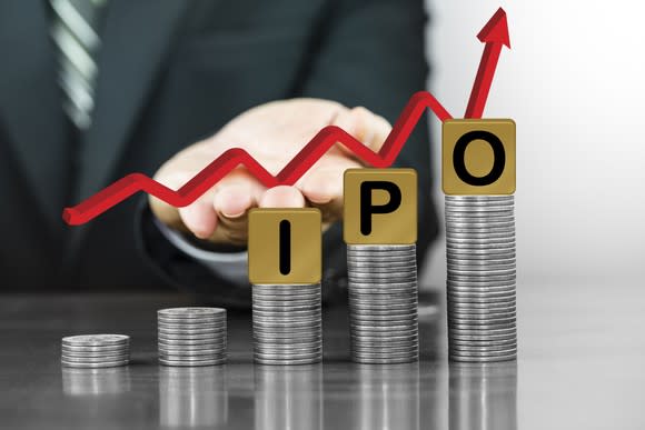 Letters IPO on stacks of coins with a rising arrow