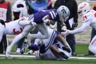 Kansas State running back Treshaun Ward (9) lunges for yardage while tackled by Houston linebacker Jalen Garner (36) and defensive back Adari Haulcy (24) during the first half of an NCAA college football game in Manhattan, Kan., Saturday, Oct. 28, 2023. (AP Photo/Reed Hoffmann)