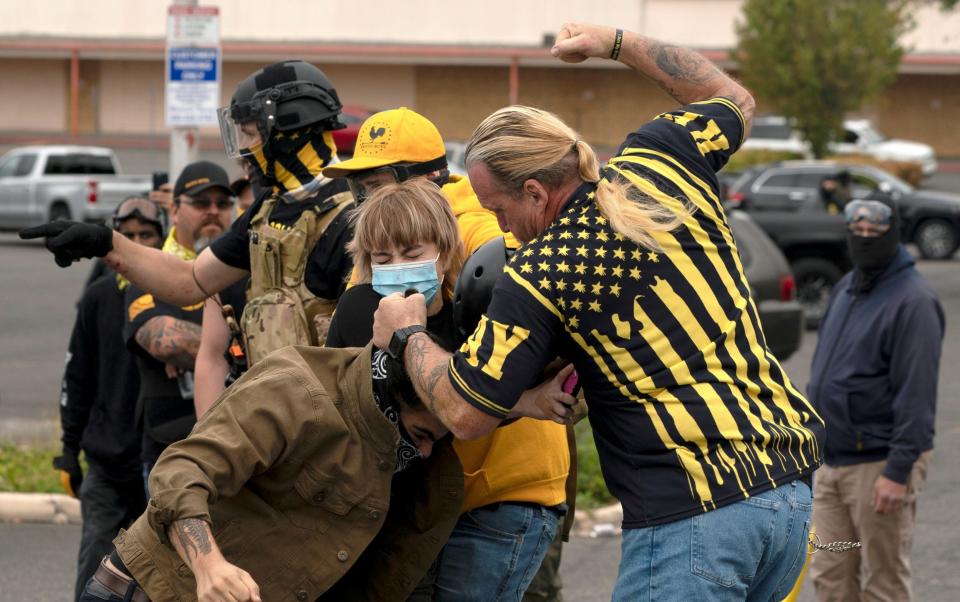 Members of the far-right Proud Boys clash with counter-protesters - DAVID RYDER /REUTERS