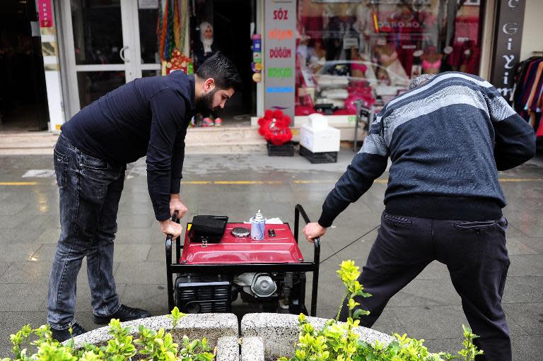 Turkish men try to start a generator on March 31, 2015 in Istanbul after a massive power cut caused chaos in large parts of the country