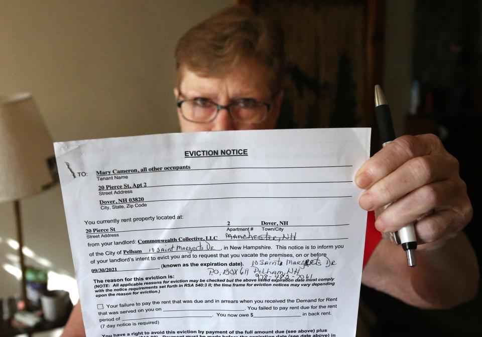 Dover resident Mary Cameron holds up the eviction notice she received Aug. 1 after being a tenant for seven years in an apartment at 20 Pierce St. She spoke about her situation on
 Tuesday, Sept.14, 2021.