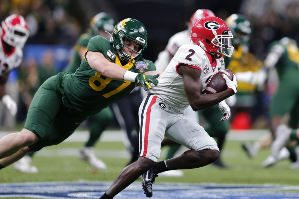 Georgia defensive back Richard LeCounte (2) returns an interception as Baylor tight end Christoph Henle (87) tries to tackle him during the first half of the Sugar Bowl NCAA college football game in New Orleans, Wednesday, Jan. 1, 2020. (AP Photo/Brett Duke)