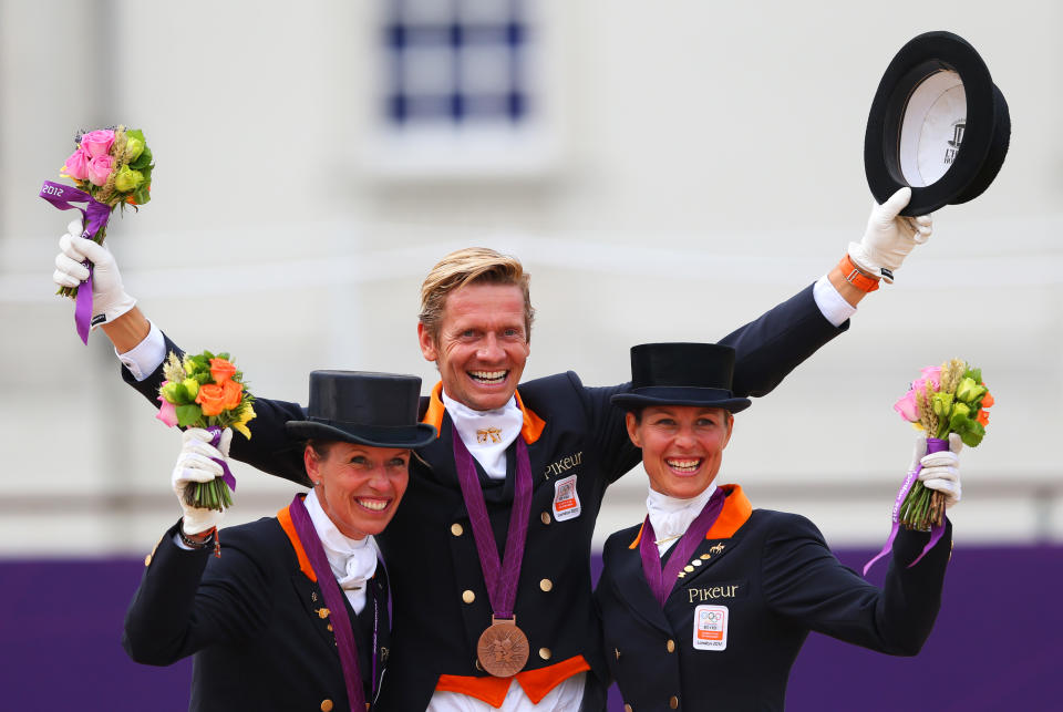 LONDON, ENGLAND - AUGUST 07: (L-R) Charlotte Dujardin, Carl Hester and Laura Bechtolsheimer of Great Britain celebrate with their gold medals during the medal cerermony for the Team Dressage on Day 11 of the London 2012 Olympic Games at Greenwich Park on August 7, 2012 in London, England. (Photo by Alex Livesey/Getty Images)