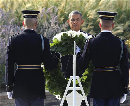 U.S. President Barack Obama lays a wreath before remembrance ceremonies for 9/11 victims at the Pentagon 9/11 Memorial in Washington September 11, 2013. REUTERS/Gary Cameron