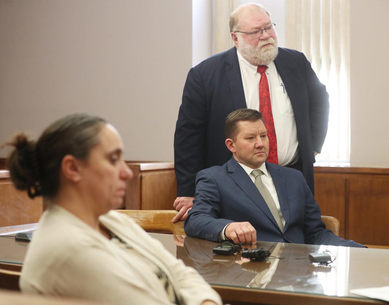 Barberton City Prosecutor Jennifer Roberts listens to defense attorney Mike Callahan address the court on behalf of his client, former State Rep. Bob Young, during Young's sentencing Friday in Barberton Municipal Court.