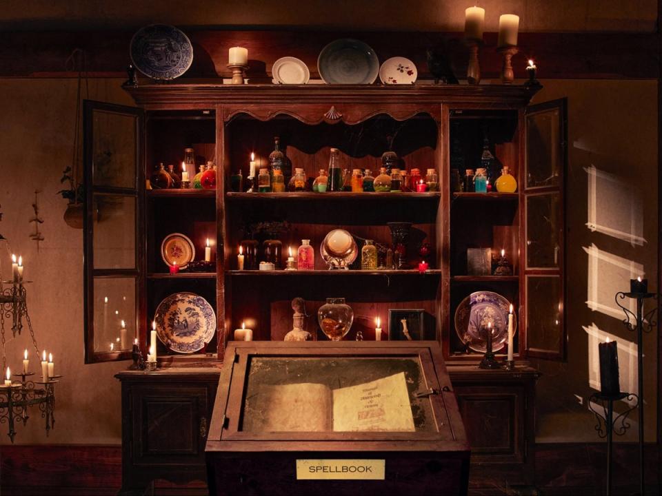 The ‘spellbook’ stands in front of a sideboard filled with bottles of potions (Helynn Ospina/Airbnb)