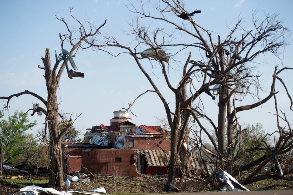 The heavily damaged Sharkey County Courthouse in Rolling Fork, Miss., stands framed by debris-filled trees Saturday, March 25, 2023, after a tornado devastated the Delta town Friday night.