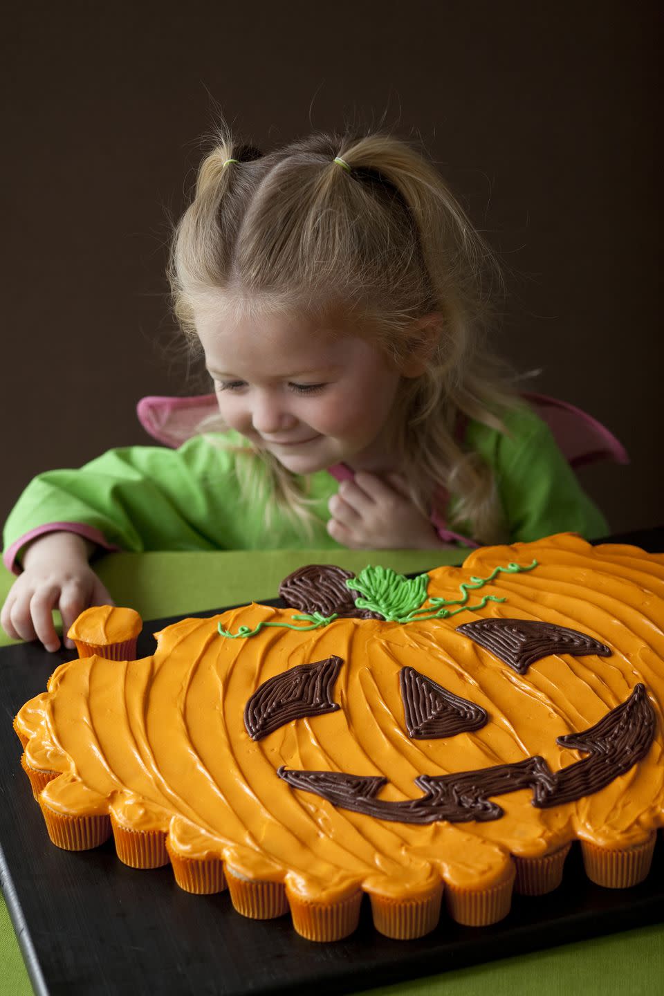 <p>There's nothing more classically Halloween than a pumpkin, so why not create a giant pumpkin cake out of dozens of cupcakes?</p><p><em><a href="https://www.womansday.com/food-recipes/food-drinks/recipes/a11046/pumpkin-patch-pull-apart-recipe-122474/" rel="nofollow noopener" target="_blank" data-ylk="slk:Get the recipe for Pumpkin Patch Pull-Apart Cake.;elm:context_link;itc:0;sec:content-canvas" class="link ">Get the recipe for Pumpkin Patch Pull-Apart Cake.</a>.</em></p>