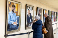 Visitors examine Artist Betsy Ashton's exhibition, "Portraits of Immigrants: Unknown Faces, Untold Stories" at Riverside Church in New York, U.S., March 10, 2019. REUTERS/Demetrius Freeman