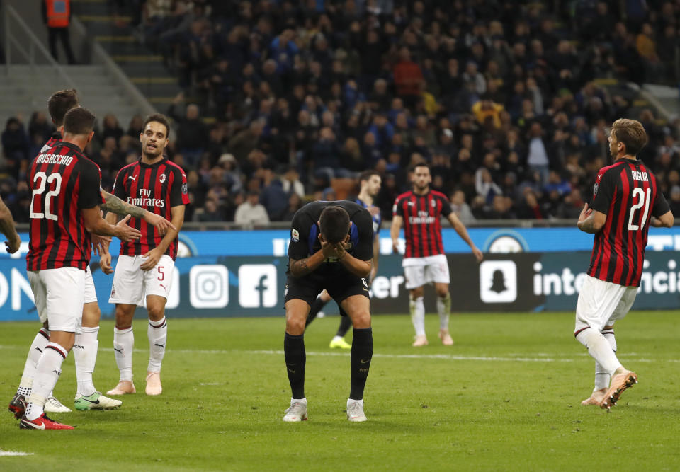 Inter Milan's Matias Vecino, center, reacts after missing a scoring chance during the Serie A soccer match between Inter Milan and AC Milan at the San Siro Stadium, in Milan, Italy, Sunday, Oct. 21, 2018. (AP Photo/Antonio Calanni)