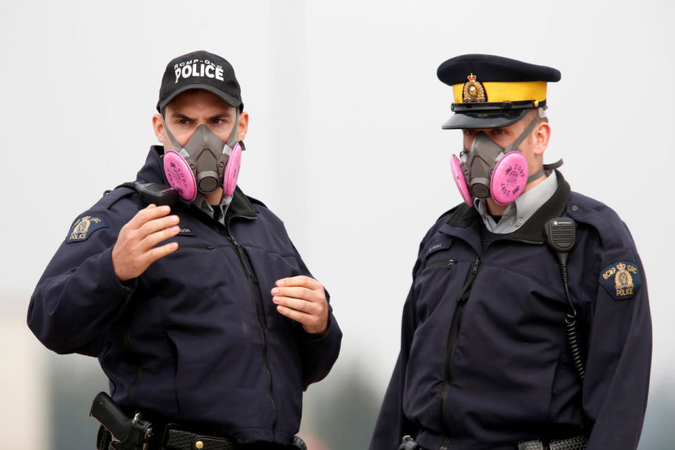 Police officers wear masks