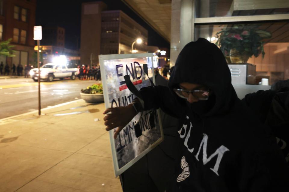 A demonstrator rallies for police reform in September 2020 in Rochester, New York, after the death of Daniel Prude at the hands of police.