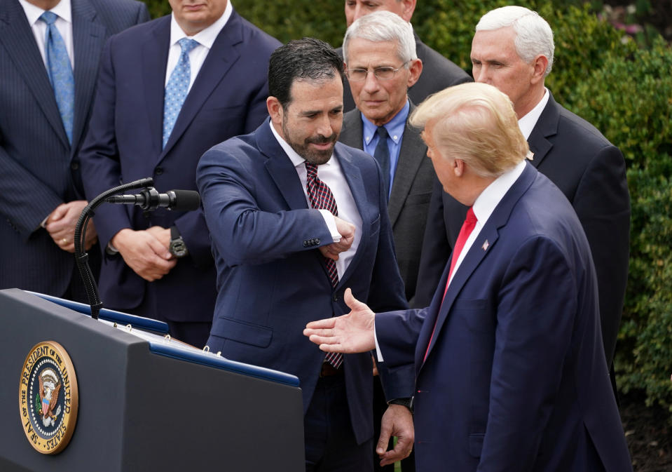 Bruce Greenstein, Executive Vice President and Chief Strategy and Innovation Officer of the LHC Group offers President Donald Trump an elbow bump in place of a handshake for safety as Dr Anthony Fauci and Vice President Mike Pence look on after the president declared the coronavirus pandemic a national emergency at a news conference in the Rose Garden of the White House in Washington, U.S., March 13, 2020. (Kevin Lamarque/Reuters)