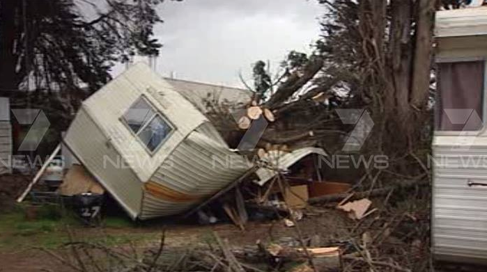 The man was treated for minor injuries after a tree fell on his caravan south of Dandenong. Photo: 7 News.