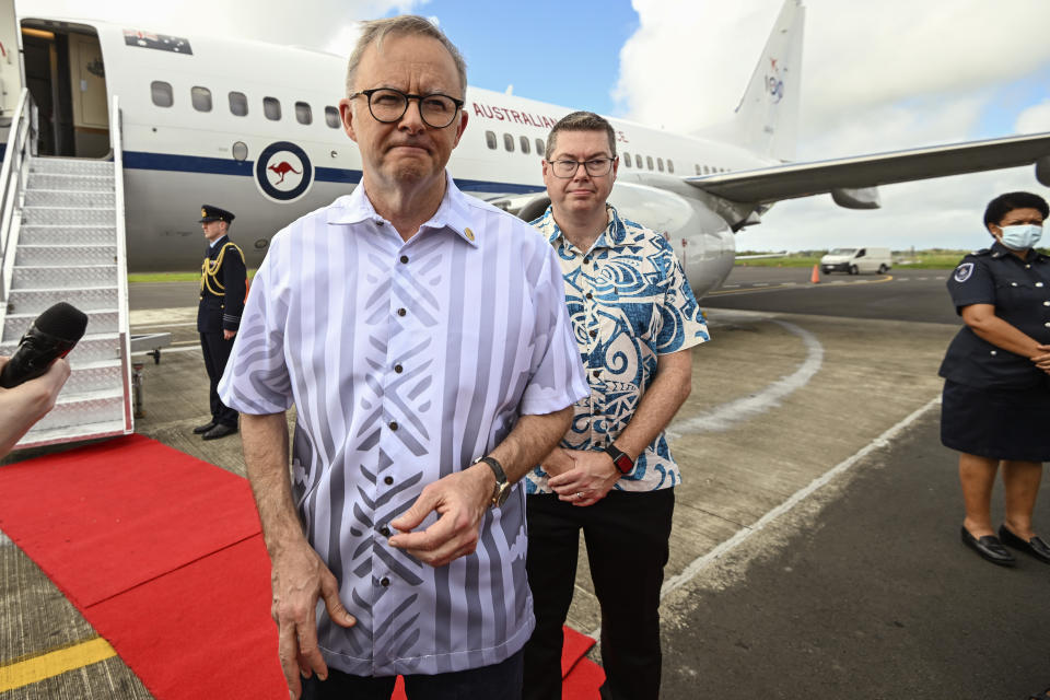 Australian Prime Minister Anthony Albanese, left, is met Pat Conroy, Australia's Minister for Defence Industry as he arrives in, Suva, Fiji, Wednesday, July 13, 2022. Albanese is attending the Pacific Islands Forum meeting as China vies for more influence in the Indo-Pacific region. (Joe Armao/Pool via AP)