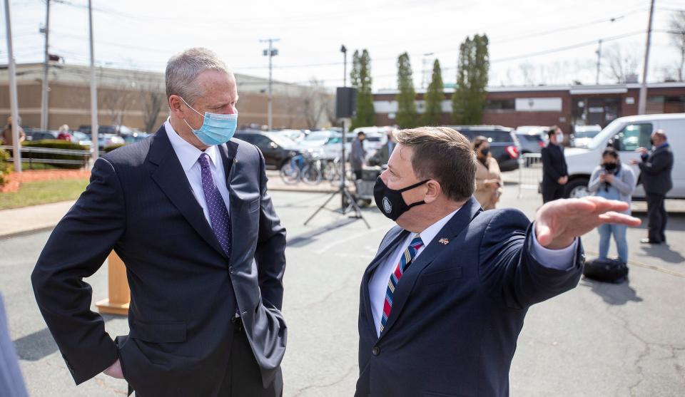 Quincy Mayor Thomas Koch, right, speaks with Gov. Charlie Baker at Father Bill's & MainSpring in Quincy on March 31, 2021.