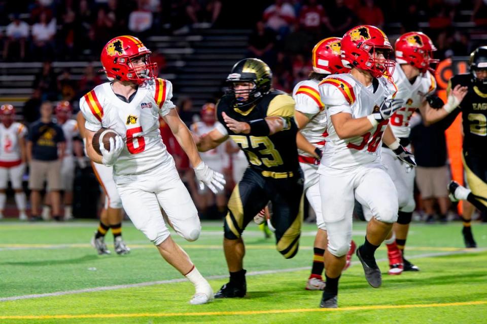 Chase Lopez, 6 of Oakdale High works his way around the line as Enochs defenders close in during the Oakdale vs Enochs game Friday Sept. 22, 2023