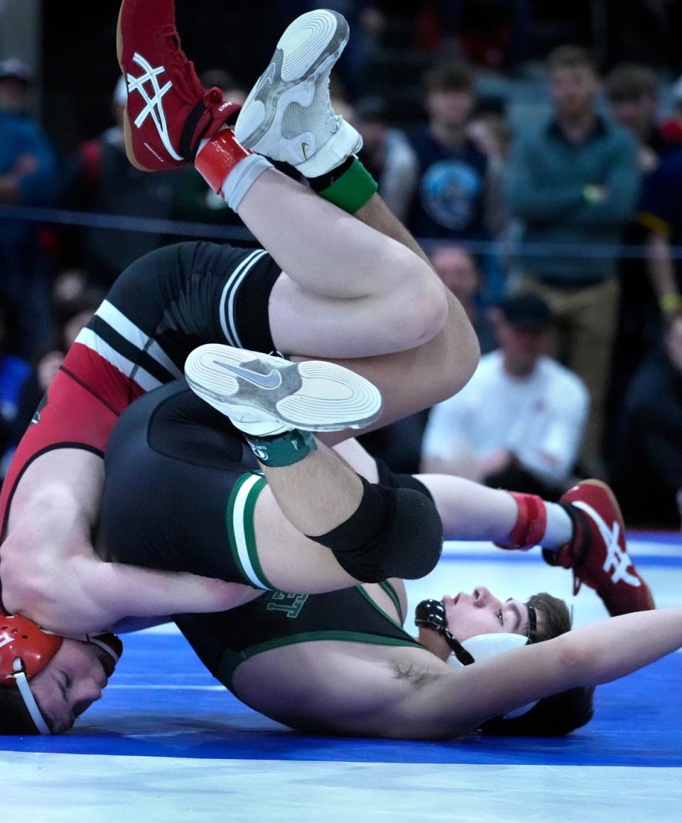 Ponaganset's Jared Hood rolls over with his finals opponent during the New England Wrestling Championships at the Providence Career and Technical Academy on Saturday.